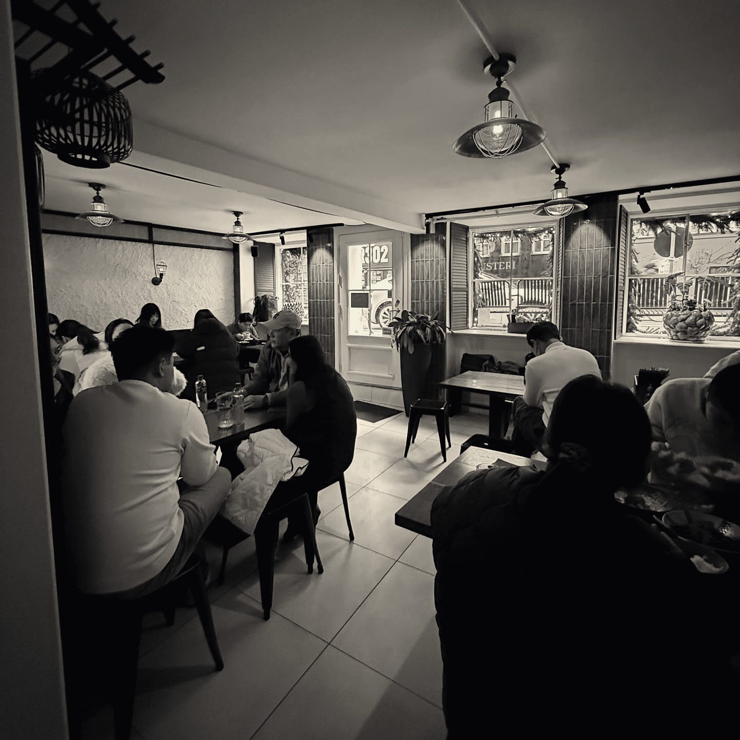 The dining room at Charm with guests at small tables